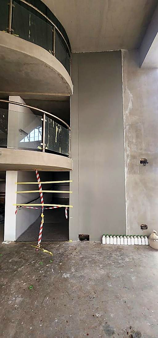 Curved concrete balustrade and stair void in a commercial building under renovation