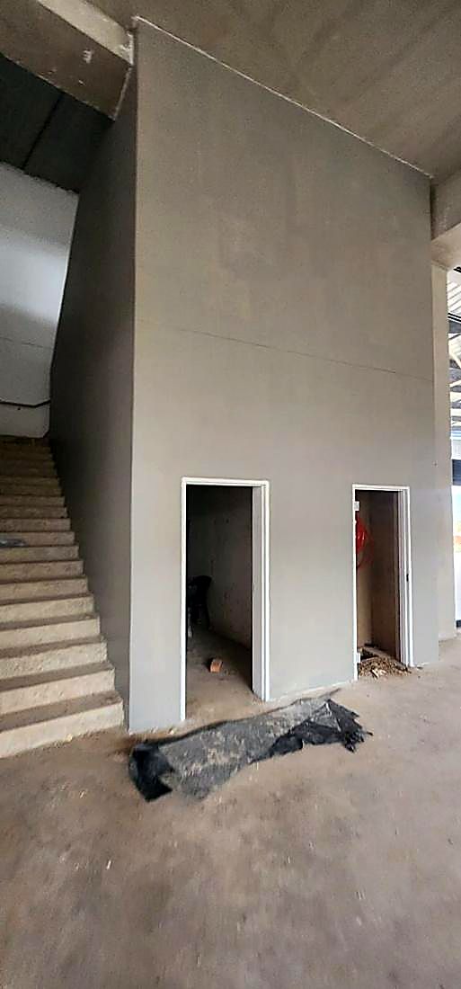 Newly formed door openings and plastered walls on a building renovation project