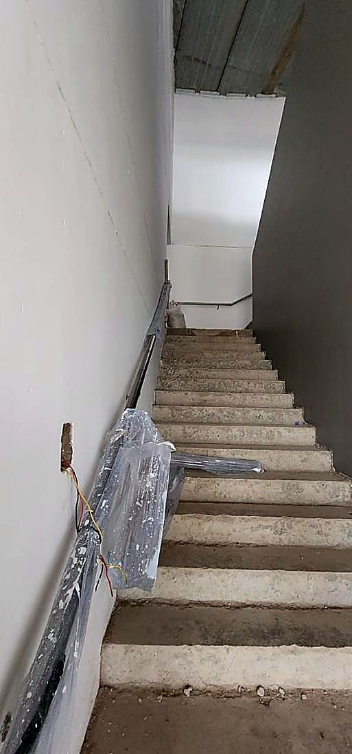 Concrete stair core with protective wrapping during building renovation