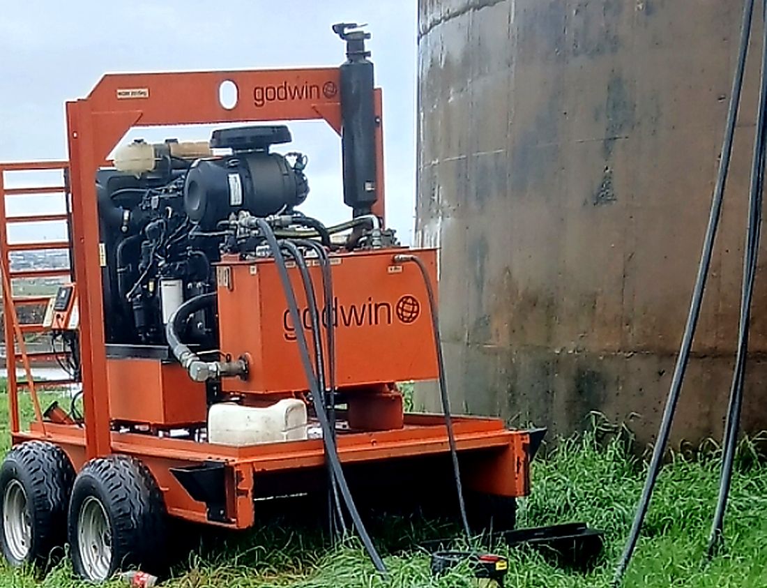 Diesel driven Godwin dewatering pump set positioned alongside a water reservoir