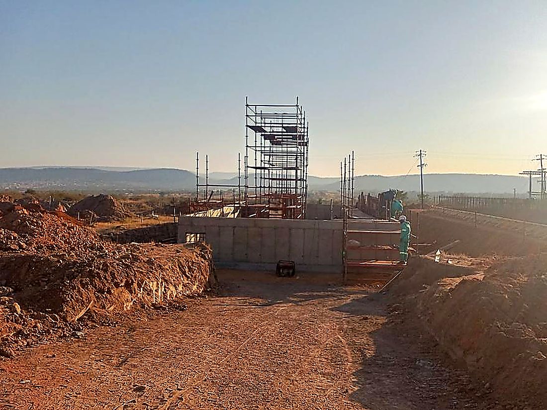 Concrete structure and scaffolding silhouetted against a highveld sunset